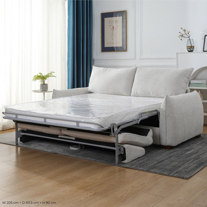 Franka Sofa Bed mid fold-out showing the pull-out mechanism and extended mattress in a living room