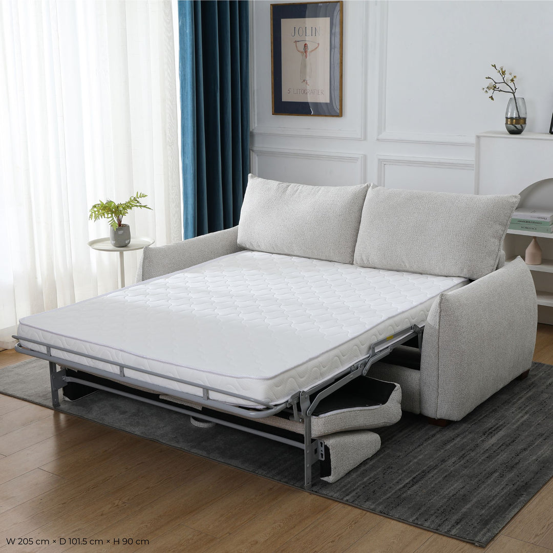 Franka Sofa Bed folded out into a double bed with the mattress extended, styled in a living room, angled view