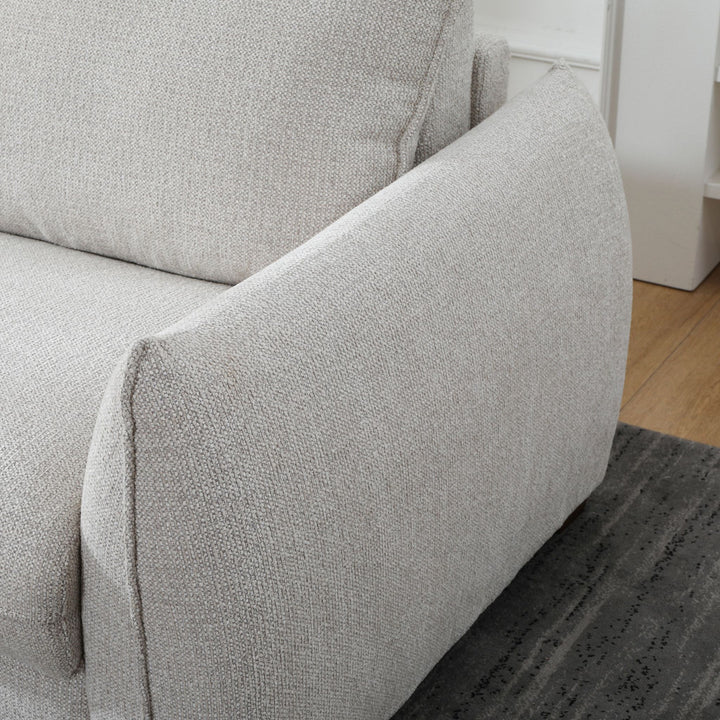 Close-up of the Franka Sofa Bed's curved armrest in light grey woven fabric