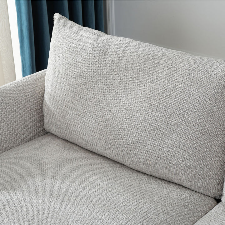 Close-up of the Franka Sofa Bed's plump back cushion and light grey woven fabric seat