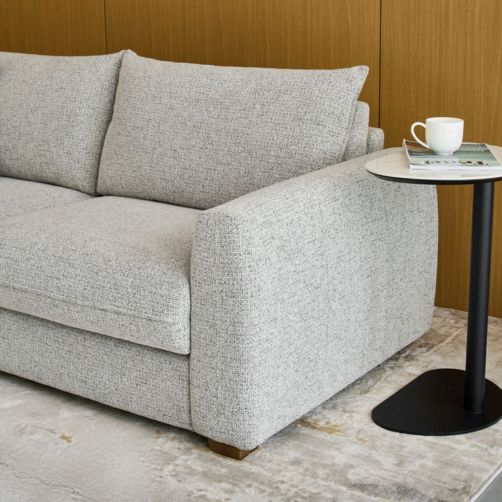 Close-up of the Nadia Sofa Bed's rounded arm and textured fabric