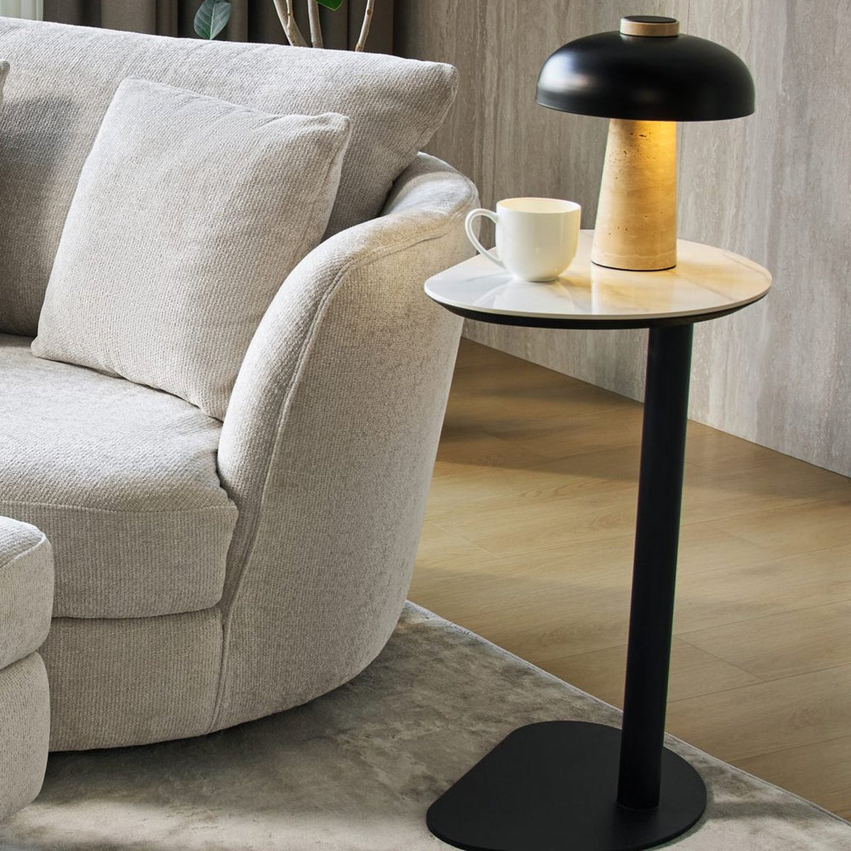 Ava Side Table holding a table lamp and coffee cup beside an accent chair