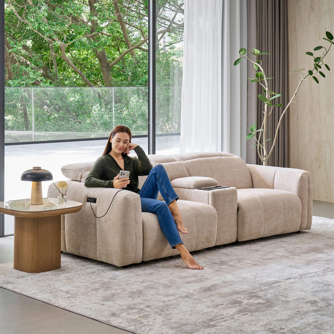 Woman on the Bailey 2 Seat Sofa with a Sofa Media Console, charging her phone