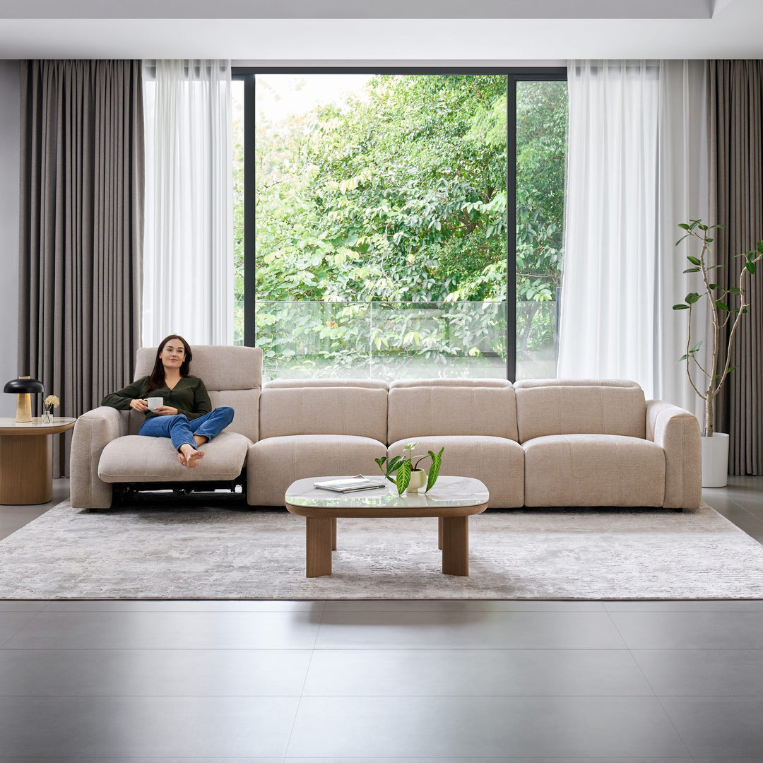 Woman relaxing on the Bailey 4 Seat Sofa with the end seat reclined