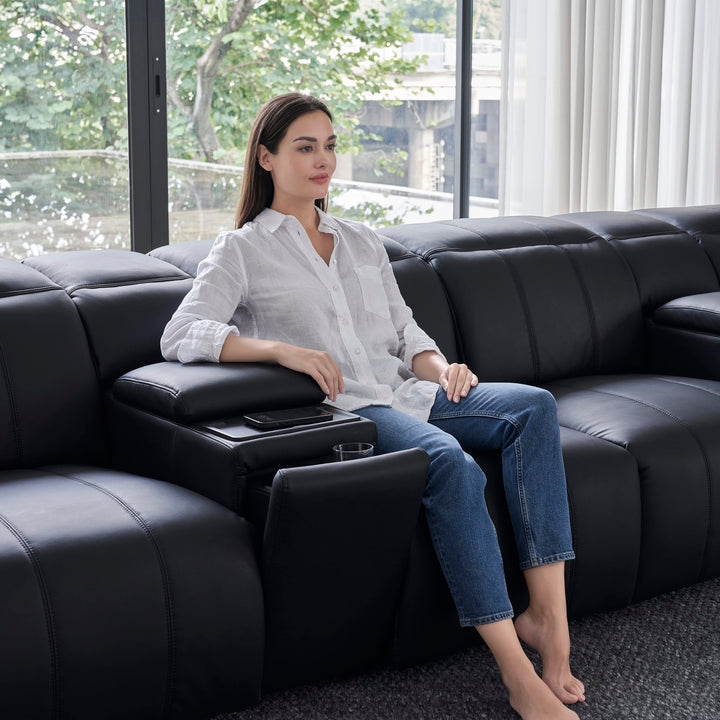 Woman seated beside a Bailey Home Theatre Sofa console in black leather