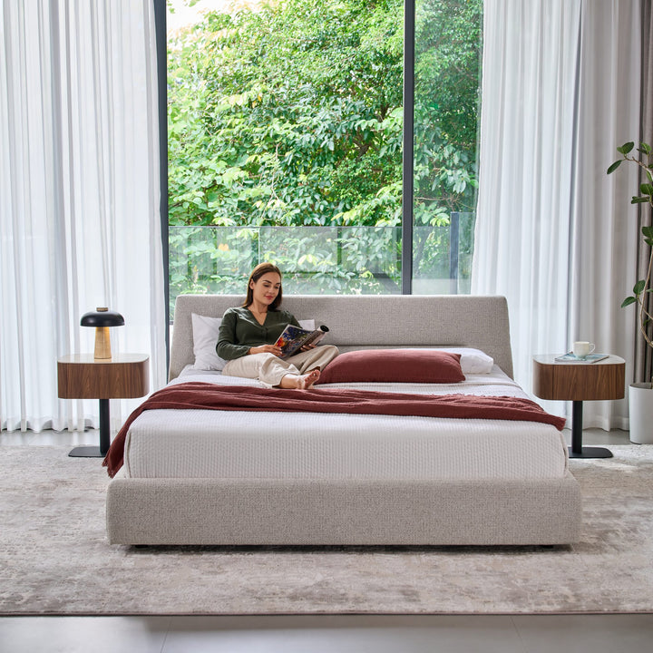 Woman reading on the Brooklyn bed in light grey