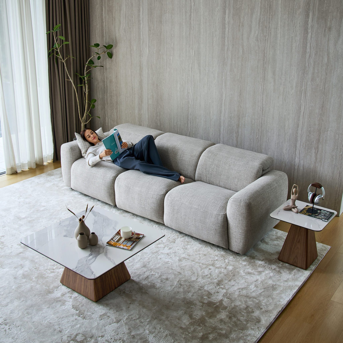 Woman lying on a Cambridge 3 seat sofa in light grey fabric, seen from above
