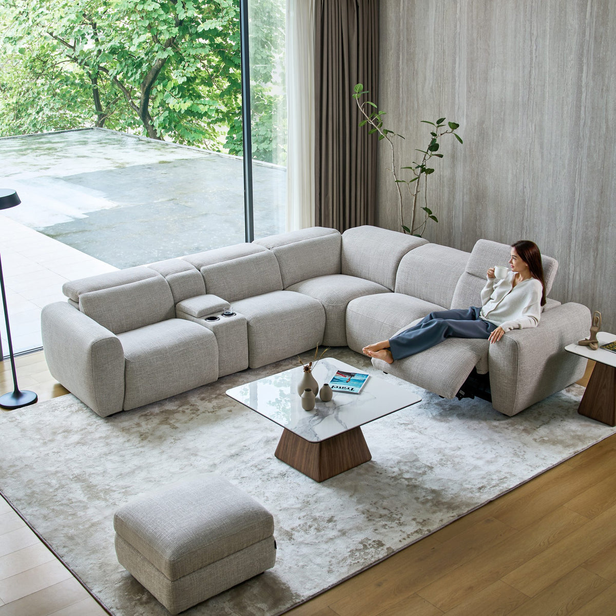 Cambridge corner sofa in light grey fabric with a media console and storage footstool