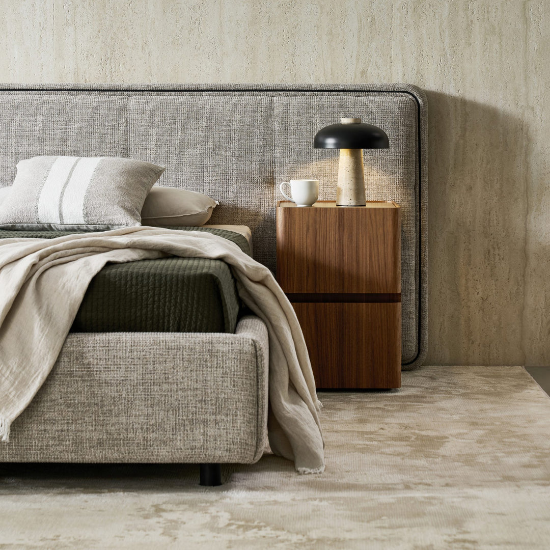 Clara Bed foot corner, showing the rounded upholstered base
