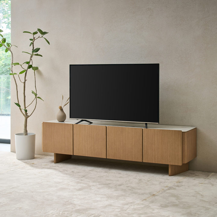 Iris TV Unit in Boston Oak, angled view of the four handle-free doors and panel legs