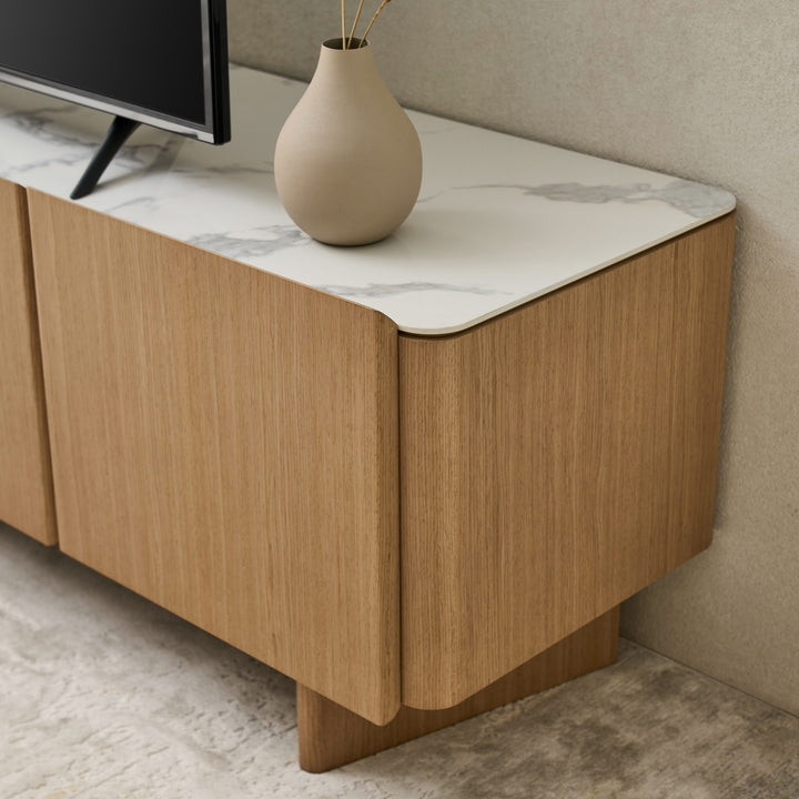 Close-up of the Iris TV Unit's rounded Boston Oak corner and Bianco ceramic stone top