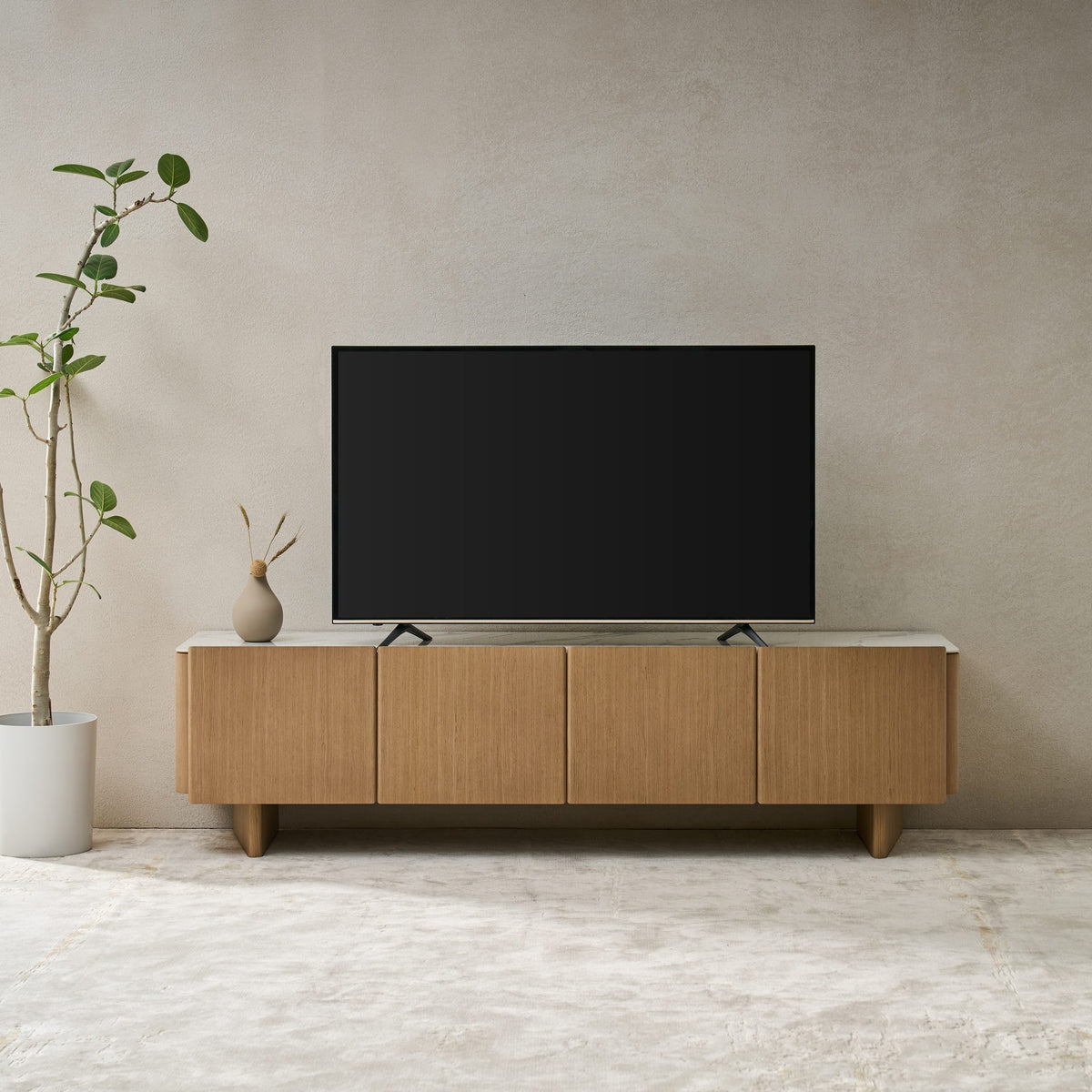 Iris TV Unit in Boston Oak with a Bianco ceramic stone top, front view in a living room