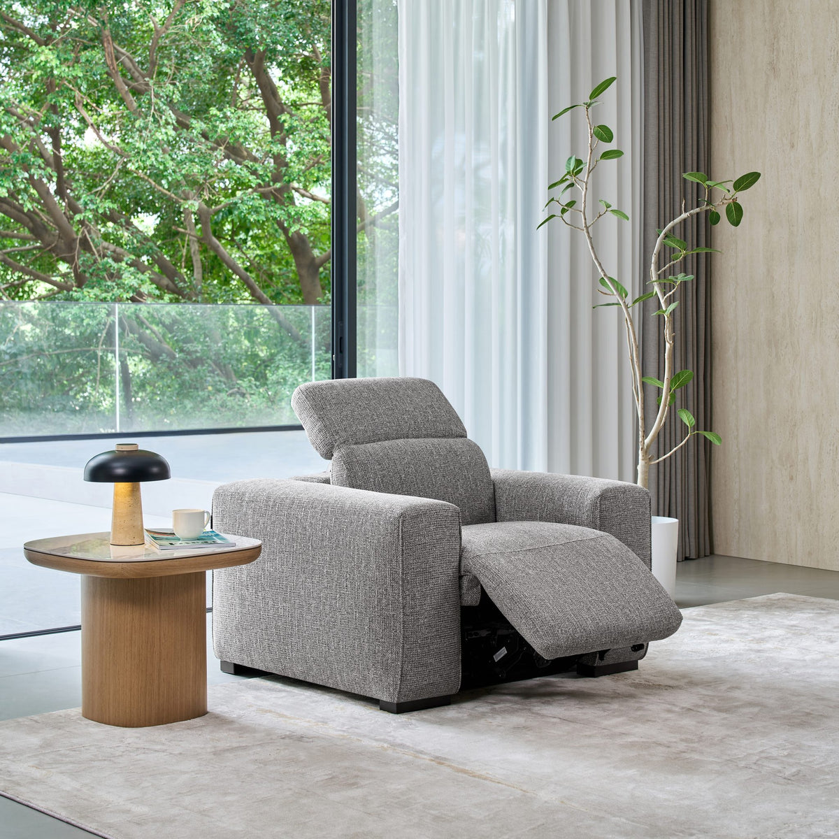 Jeddah recliner armchair in grey fabric, reclined with the headrest raised