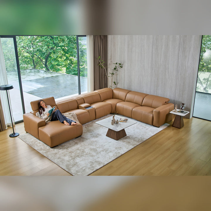 Overhead view of the Jeddah U-shape corner sofa in tan leather with a woman reclining