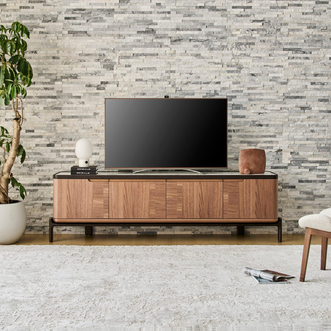 Rowan TV Unit in American Walnut with Black Oak legs and a Bianco ceramic stone top, front view